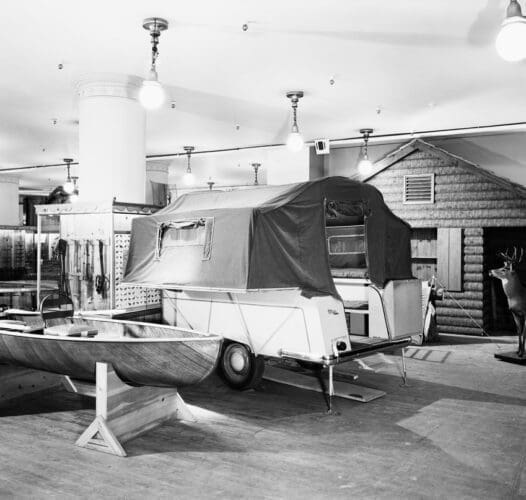 Interior view of camping display in Sports department in Store for Men of Marshall Field & Company on the corner of Washignton and Wabash, Chicago, Illinois, October 9, 1946. The view includes a boat, a camper, tents, a faux deer and a model cabin.